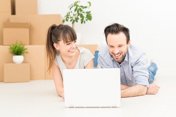 couple laying on computer